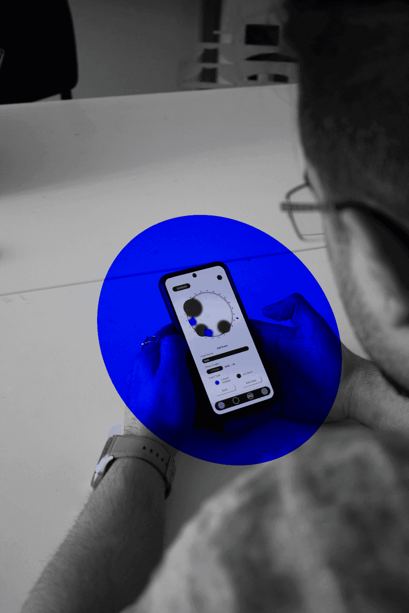 Over-the-shoulder photo of a participant using the Memor prototype on a phone.